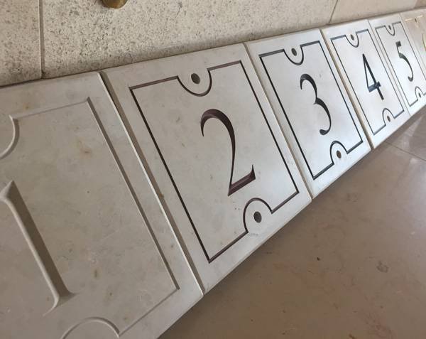 Engraving on street number in natural limestone Engraving on street number in natural limestone