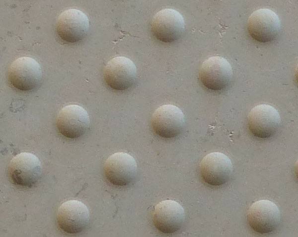 Detail of tactile paving slab in limestone