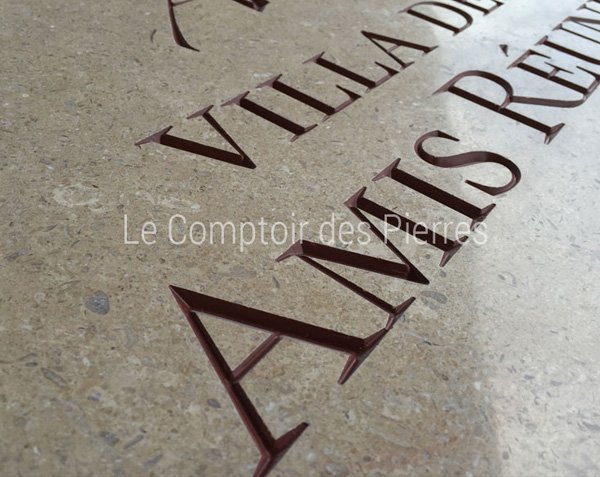 Detail of recessed engraving on Burgundy stone Detail of recessed engraving on Burgundy stone