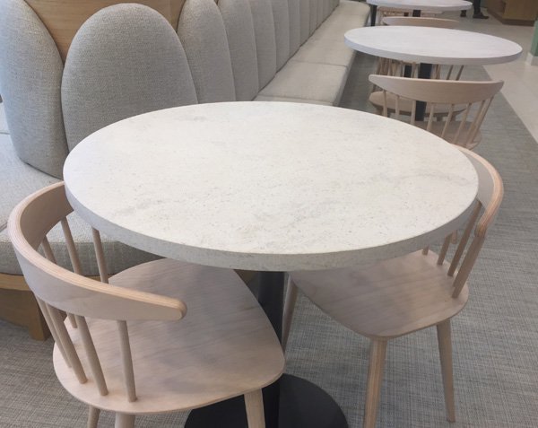 Round dining table. Charmot Light Honed