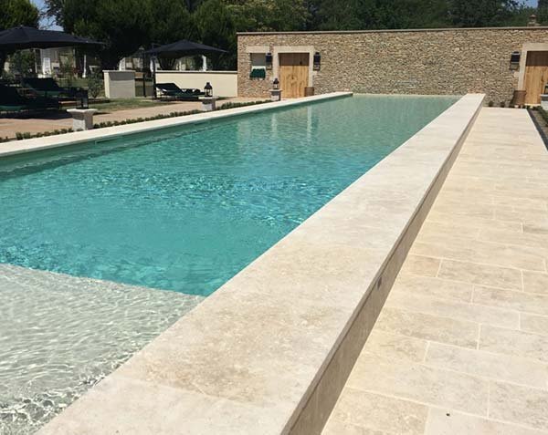 Outdoor development - Pool coping and paving in natural Burgundy limestone.