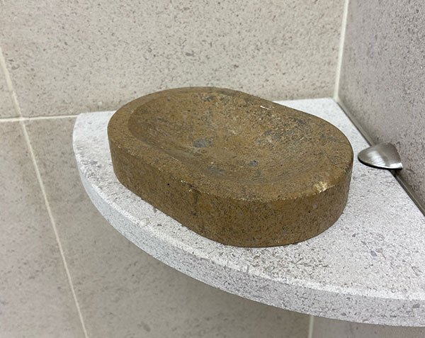 Brown Lanvignes Antiquaire stone soap holder on a corner shelf in Softened Charmot Clair
