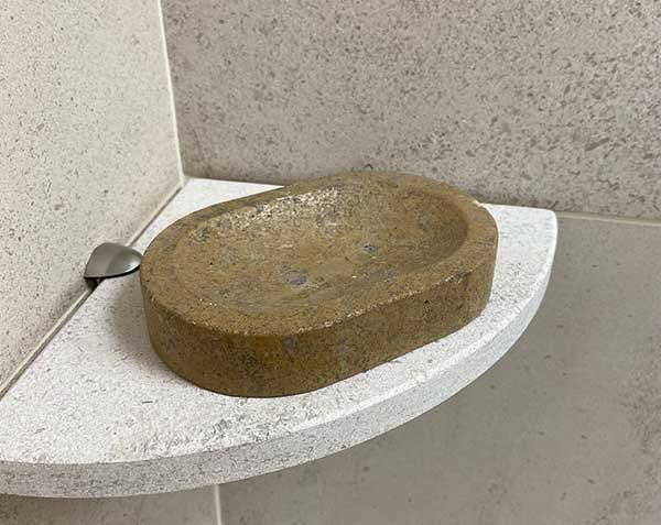 Lanvignes Antiquaire stone soap holder on a corner shelf in Softened Charmot Clair