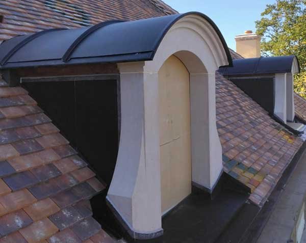 Natural Burgundy stone roof dormer with glazed tiles