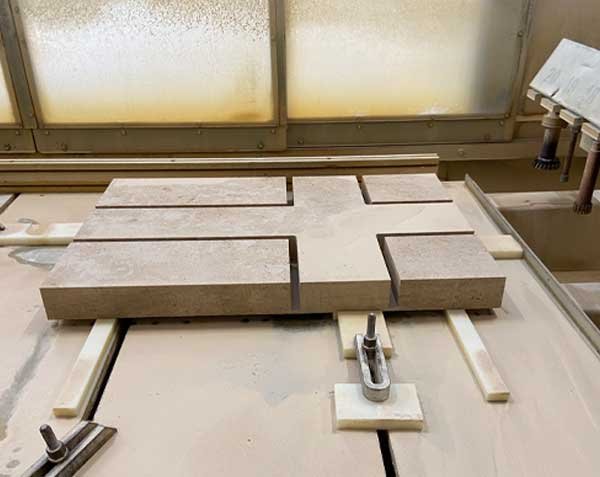 Machining of a solid natural stone cross