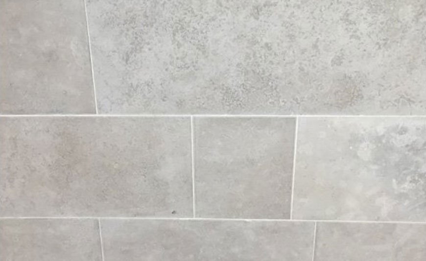 Pose du carrelage mural en pierre de l’espace douche